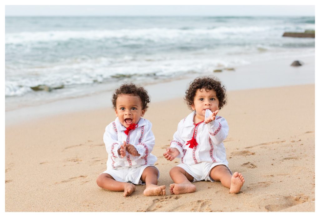 Twins on the beach in traditional Romanian outfits